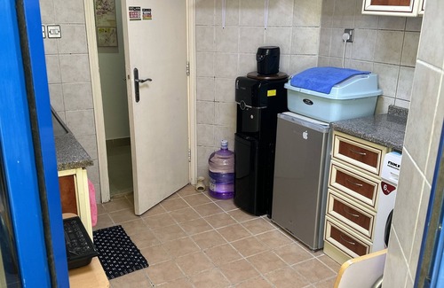 Al Zahiyah Apartment | a charming and cozy purple themed room within the heart of the city .