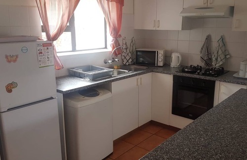 Hartenbos House | A comfortable livingroom, fully equipped kitchen make you feel at home apartment