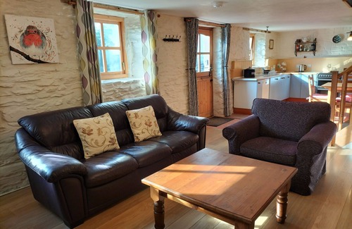 Lampeter Cottage | A cosy former horse stable with stone walls and old beams throughout