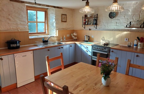 Lampeter Cottage | A cosy former horse stable with stone walls and old beams throughout