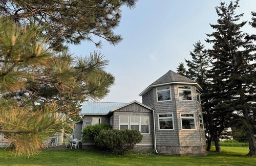 Cap-Pele Ski Chalet | A cottage among the trees, a cape, a beach.