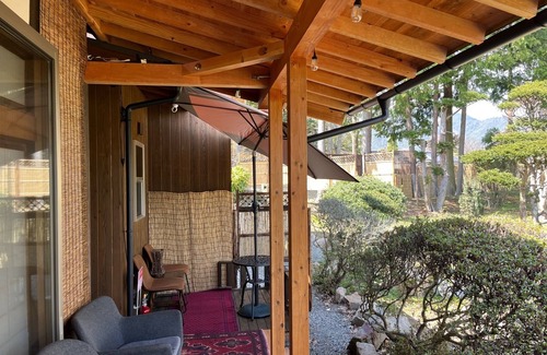 Matsukawa Cottage | A detached room with a cypress bath overlooking the garden and a large deck/Kitaazumigun Nagano
