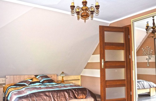 Lubna House | A luxury home on the shore of the lake. Living room with fireplace, 2 bedrooms.