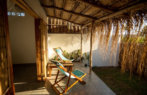 Tofo Apartment | Air conditioned en suites with King size beds and mini fridges with verhanda