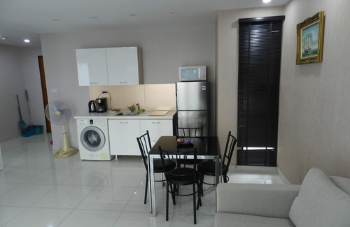 Jomtien Apartment | Apartment bedroom + living room.