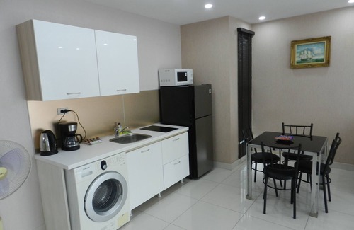 Jomtien Apartment | Apartment bedroom + living room.