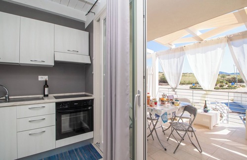 Trinita d'Agultu e Vignola Apartment | Apartment "Ulivi 17" with Sea View, A/C, Terrace, Reserved Parking and Wi-Fi