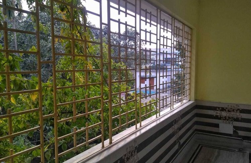 Siliguri Apartment | Bashundhara- A beautiful, spacious room with a bath and balcony.