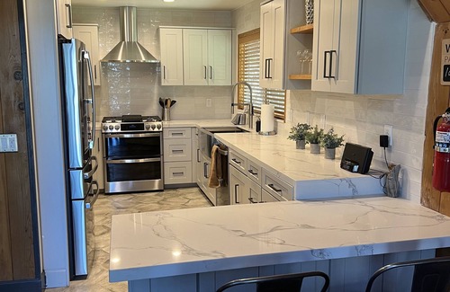 Blue Jay Cabin | Beautiful updated 3 level home with high ceilings, a wall of windows & game room