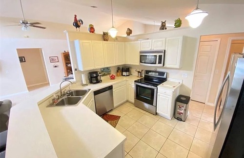 Sunridge Woods House | Beautiful waterfront home with heated pool and game room.