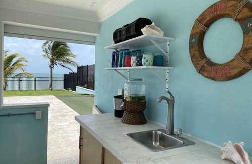 Coral Harbour House | Blue Birds Beach House, right on the beach with a large backyard & heated pool.