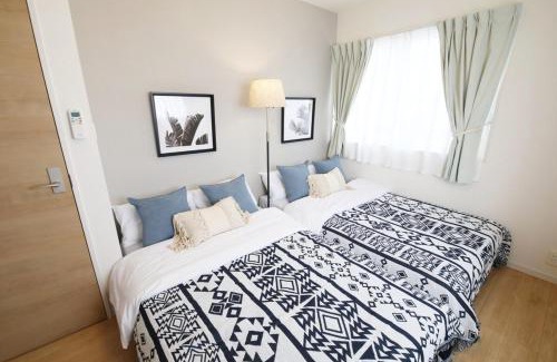 Ojima Island Apartment | blue sea and house