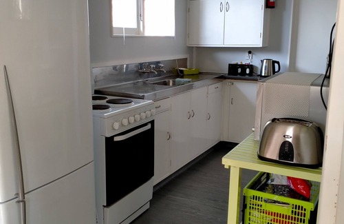 Waikanae House | Bright airy classic Bach ~ near beach ~ quiet location ~ grassy section.
