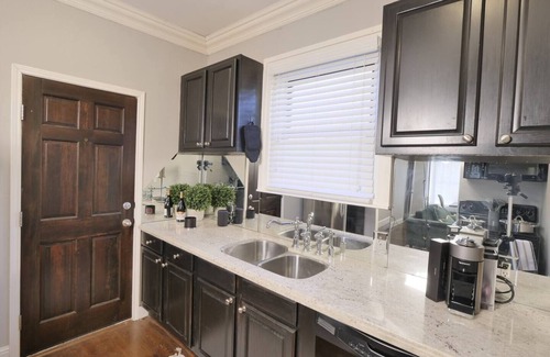 Old East Dallas Condo | Bright and refined 1BR condo on historic Swiss Avenue, featuring high-speed Wi-Fi, a plush queen bed, and a stylish living area with crystal lighting. Oversized windows fill the space with natural light, blending timeless charm with modern comfort.