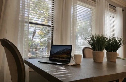 Old East Dallas Condo | Bright and refined 1BR condo on historic Swiss Avenue, featuring high-speed Wi-Fi, a plush queen bed, and a stylish living area with crystal lighting. Oversized windows fill the space with natural light, blending timeless charm with modern comfort.