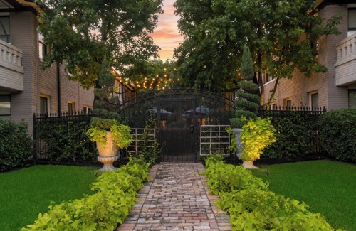 Old East Dallas Condo | Bright and refined 1BR condo on historic Swiss Avenue, featuring high-speed Wi-Fi, a plush queen bed, and a stylish living area with crystal lighting. Oversized windows fill the space with natural light, blending timeless charm with modern comfort.