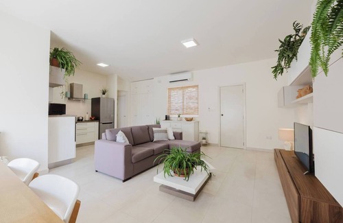 Ta' Pennellu Apartment | Bright and stylish 2-bedroom apartment in the heart of Mellieha, Malta. Located in a quiet residential area, it features a charming louvered balcony, large sunlit windows, and modern interiors with natural touches