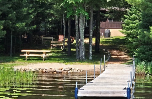Eagle River House | Cabin on Voyageur Lake–2BR Retreat on ER Chain w/Deck, Firepit & Sandy Beach!