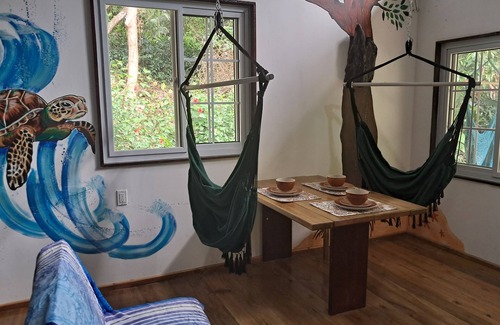 Carenero Island Cottage | Charming Tiny House, 1 minute walk to surf and beaches, peaceful.