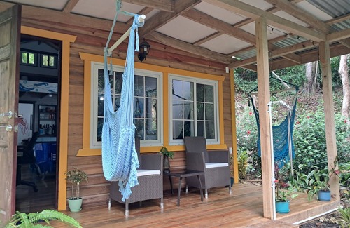 Carenero Island Cottage | Charming Tiny House, 1 minute walk to surf and beaches, peaceful.