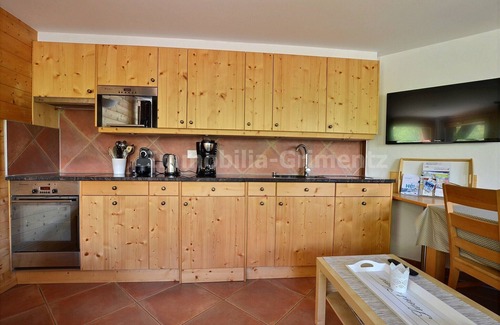 Grimentz Apartment | Comfortable flat for 5 to 6 people, living room with wood-burner and 1 divan bed, kitchen area with