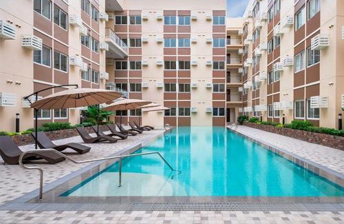Binan City Apartment | Cozy Studio near Nuvali, Enchanted Kingdom - Private Cinema with Netflix & Disney Plus with Free Pool Access