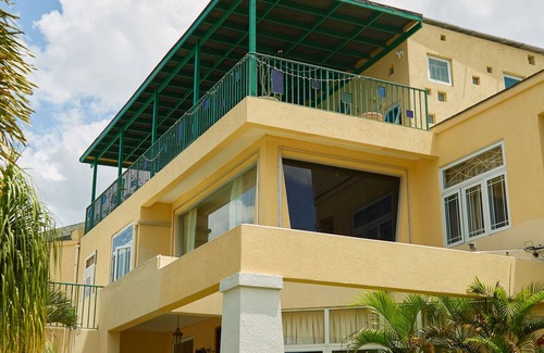 Jack's Hill House | Crowne Gardens. Safe, quiet, luxurious Kingston home with a scenic view.