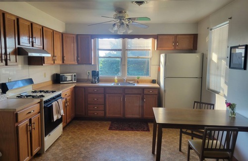 Morrell Park Hotel | Cute little cottage surrounded by shrubs, flowers, and peach trees.