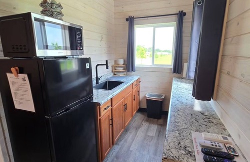 Tuscumbia Cabin | Enjoy cabin #64 at Heritage Acres Park with swimming, splash pad & more!