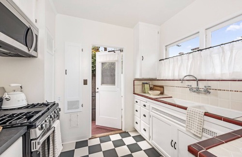 West Beach Apartment | Enjoy indoor-outdoor living, a full kitchen, and vintage coastal charm.