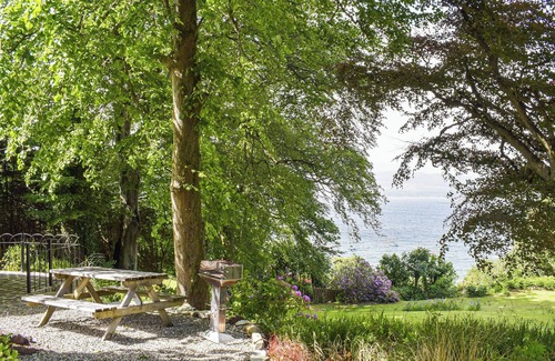 Kilcreggan Cottage | Enjoy the stunning loch views from the lounge or outdoor seating area.