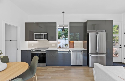 Young Harris Apartment | Enjoy treetop views in a 2BR/1BA tiny home nestled in the North Georgia mountains. Whip up meals in the chef’s kitchen, cozy up by the wood-burning stove, unplug in the spa-style shower, relax on your private deck, and cool off in the community pool.
