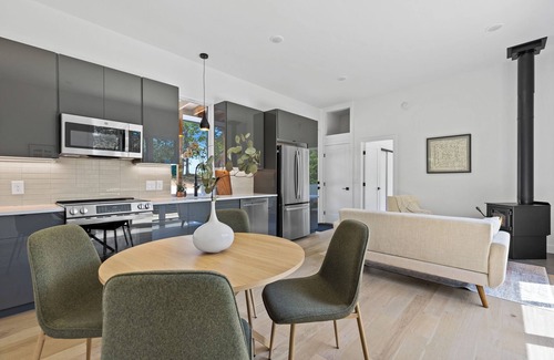 Young Harris Apartment | Enjoy treetop views in a 2BR/1BA tiny home nestled in the North Georgia mountains. Whip up meals in the chef’s kitchen, cozy up by the wood-burning stove, unplug in the spa-style shower, relax on your private deck, and cool off in the community pool.
