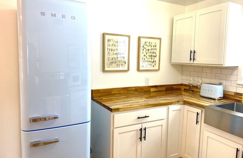 Mena Cottage | Experience History in an original Carriage House located behind a Colonial home.