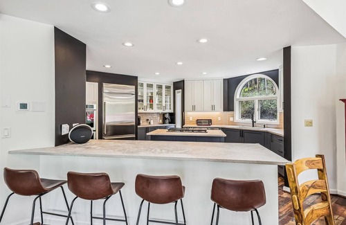 Dunkin Hill House | Experience luxury at Stormbunker Paradise, a spacious 4-bedroom house with stunning wooded views.