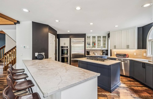 Dunkin Hill House | Experience luxury at Stormbunker Paradise, a spacious 4-bedroom house with stunning wooded views.