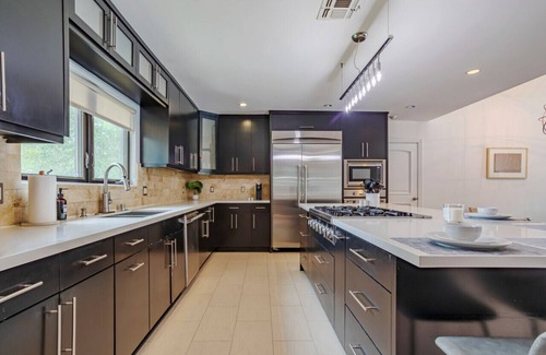 Sherman Oaks House | Exquisite Oasis Universal Pool slide laundry