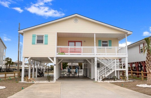 Cherry Grove Beach House | Exquisite waterfront channel home with a cozy private pool, covered porch perfect for families