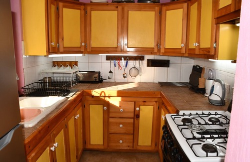 Tanetane Apartment | Family apartment large kitchen /diner opening onto a tropical garden
