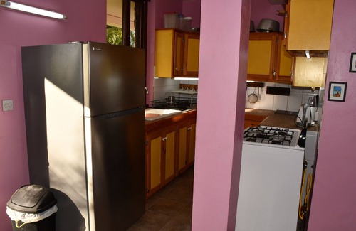 Tanetane Apartment | Family apartment large kitchen /diner opening onto a tropical garden