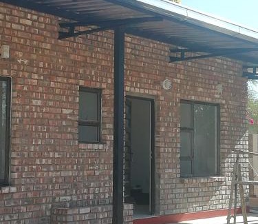 Outjo Bed & Breakfast | Farmhouse Boutique Backyard Rooms