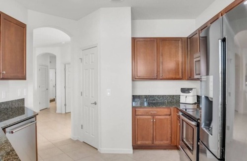 Bonita Springs Condo | First Floor Coach Home with Breathtaking Sunsets Overlooking Lake in Hawthorne