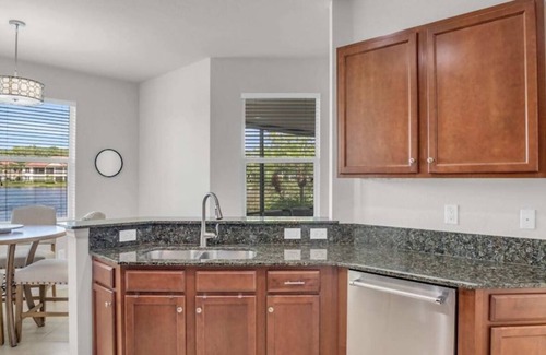 Bonita Springs Condo | First Floor Coach Home with Breathtaking Sunsets Overlooking Lake in Hawthorne