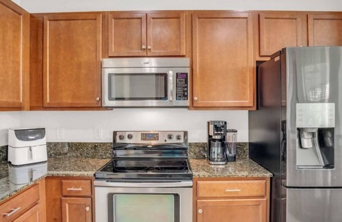 Bonita Springs Condo | First Floor Coach Home with Breathtaking Sunsets Overlooking Lake in Hawthorne
