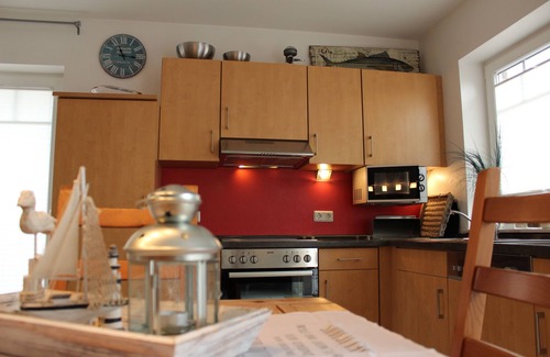 Greetsiel House | Friesenkate with garden & boat dock on the Greetsieler canals for 6 adults & baby