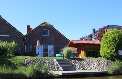 Greetsiel House | Friesenkate with garden & boat dock on the Greetsieler canals for 6 adults & baby