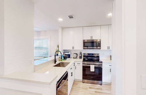 Bay Acres House | Full duplex near beach with renovated interior, screened porches-Dogs ok
