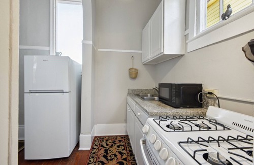 Seventh Ward Apartment | Historic Property With Balcony Lookout into Trees and Pre Civil War buildings.