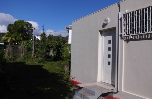 Saint-Claude House | Kitchen-living room and air-conditioned bedroom, at the foot of La Soufrière.