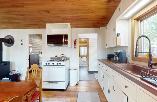 Wakefield House | Lakefront house with firepit, beach access, deck, grill, woodstove, & central AC